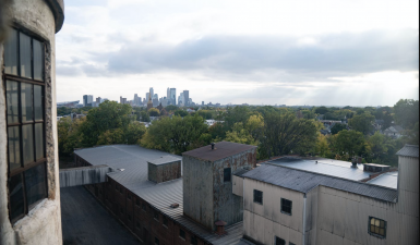 A view from one of the Northrup King's undeveloped towers, you see a distant Minneapolis skyline and other undeveloped parts of the campus in closer view.